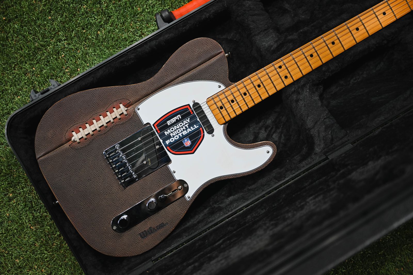 Close-up of the guitar body showing the football leather, laces and the Monday Night Football badge