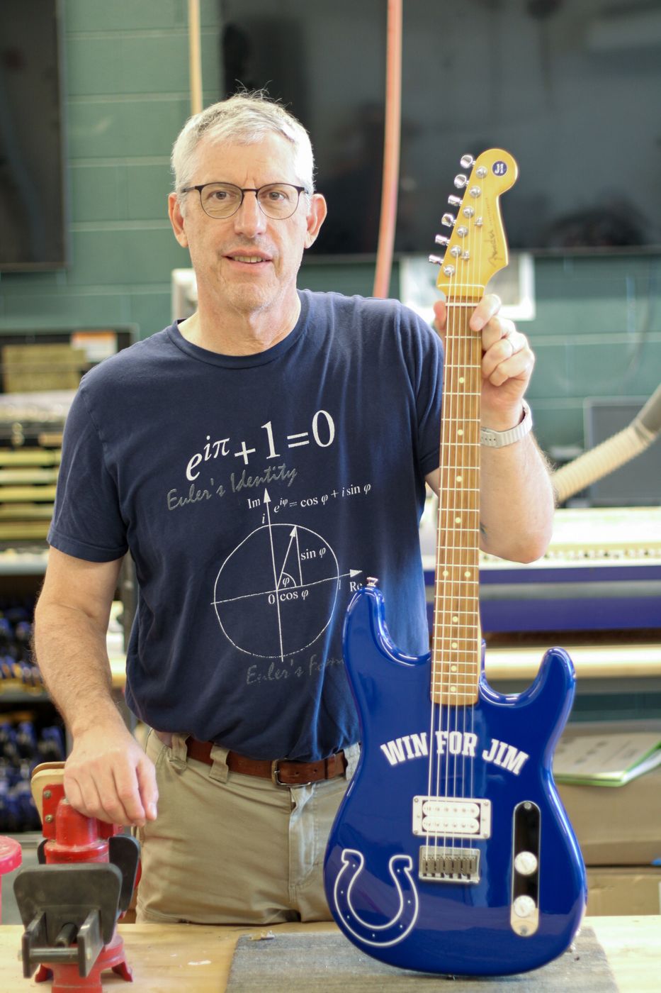 Dr. Mark French in the Purdue Guitar Lab holding the Win for Jim guitar